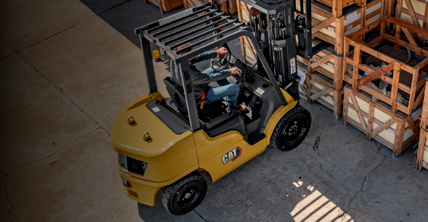 Cat IC Pneumatic tire forklift in dark warehouse